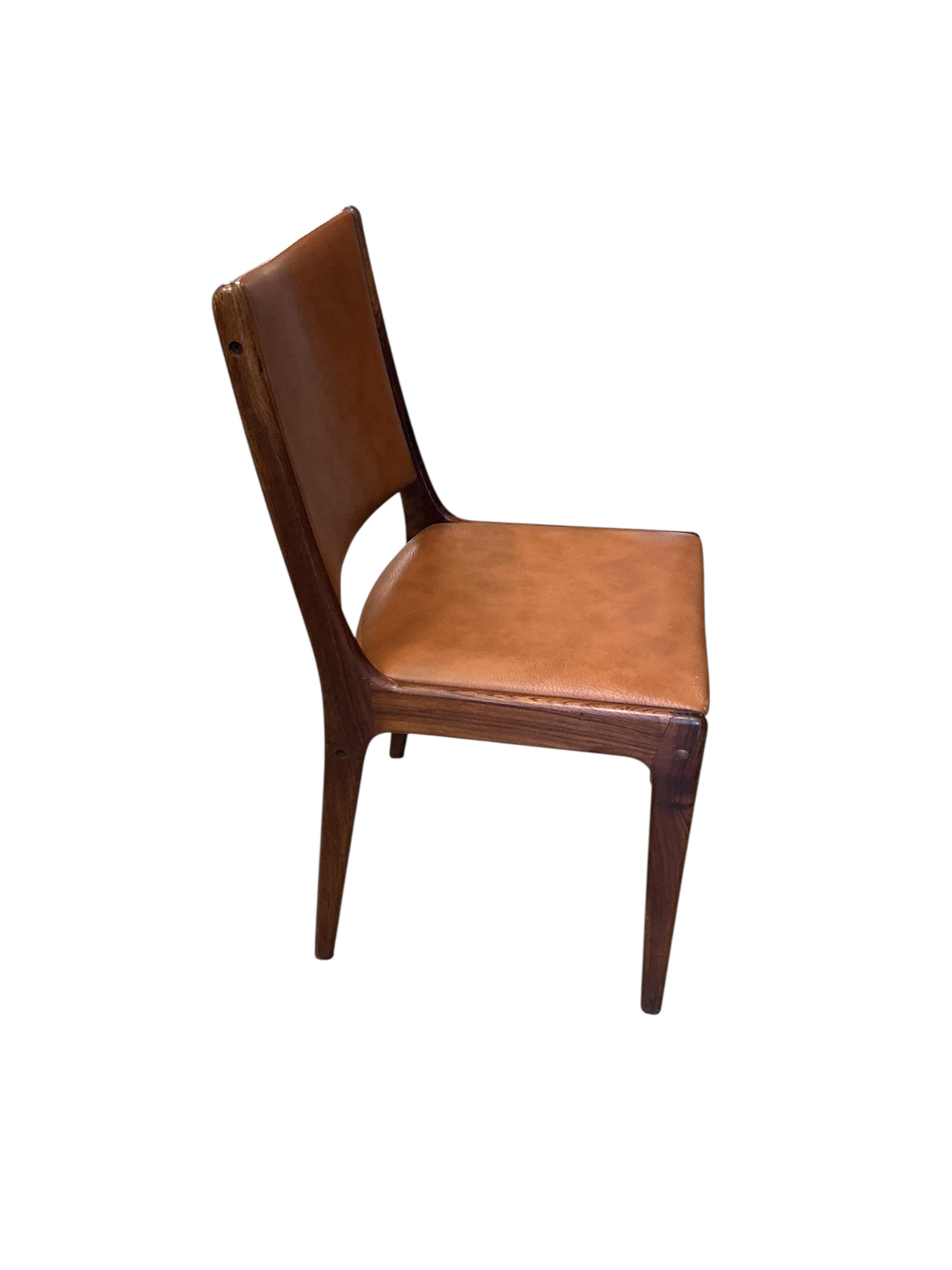 Johannes Andersen for Uldum Mobelfabrik, a set of six teak and tan leather dining chairs, width 42cm, height 84cm